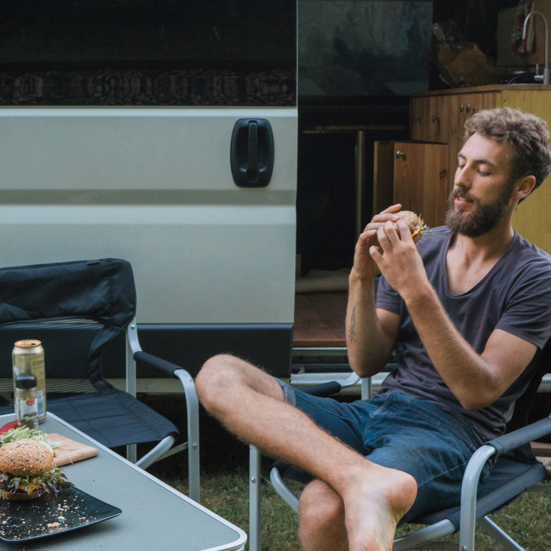 camping and eating an open fire burger