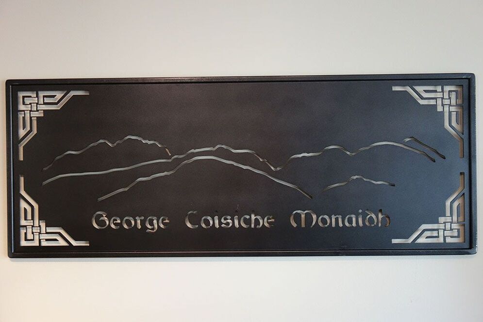 steel family name sign with scottish mountain range Bennevis
