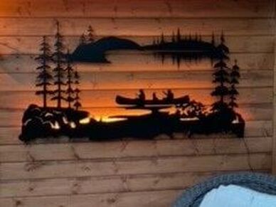 canoe and pine trees wall sign